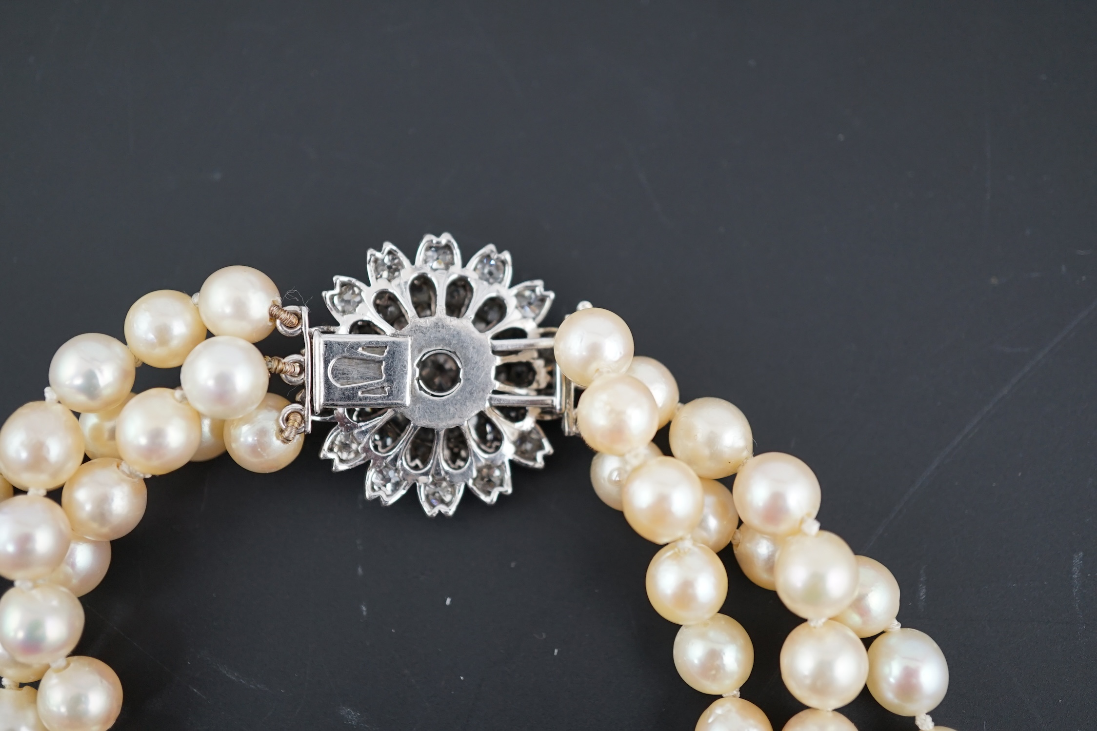 A triple strand graduated cultured pearl choker necklace, with old and rose cut diamond cluster set circular clasp